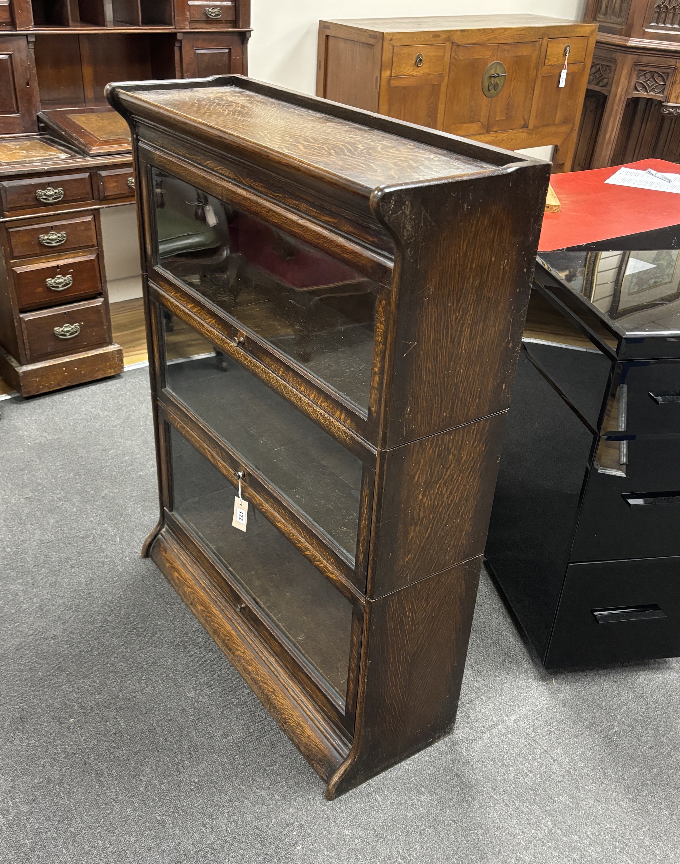 An oak Globe Wernicke style three section bookcase, width 87cm, depth 30cm, height 113cm